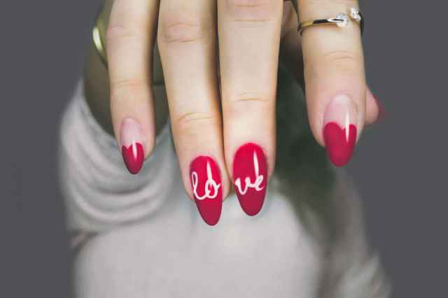 red and white manicure with love print
